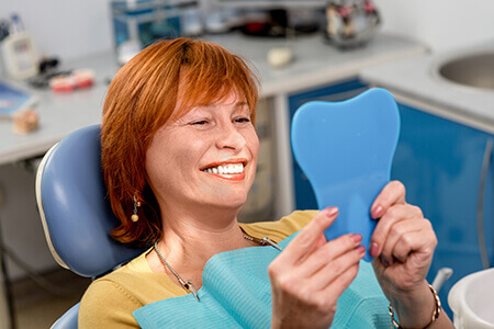 Woman happy with smile after dentist visit